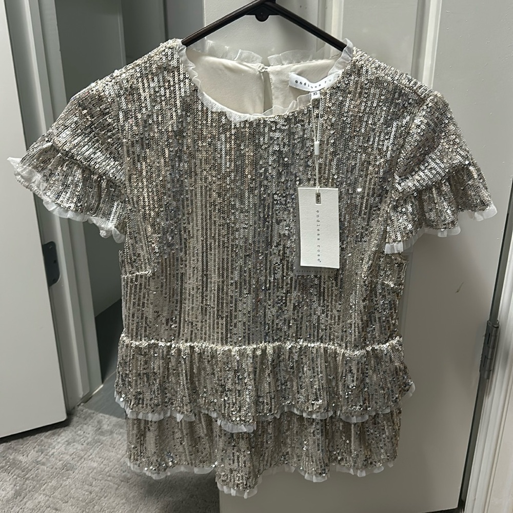 XS endless rose champagne pepulum top.
